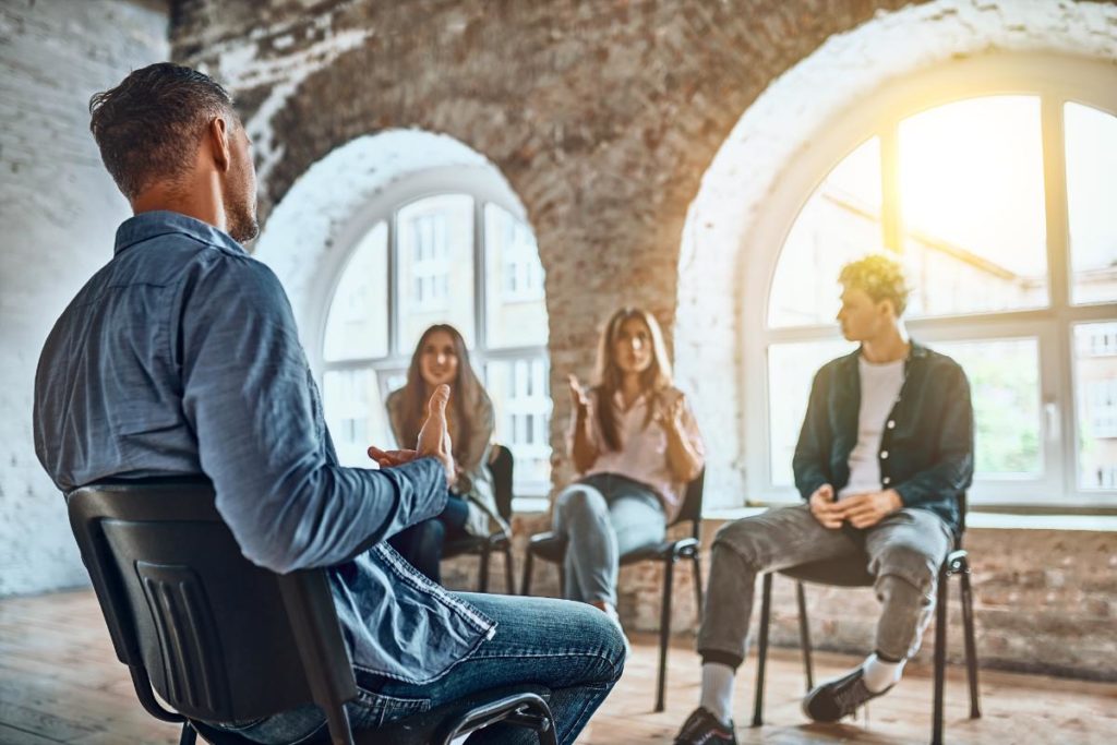 a group talks in a heroin detox center