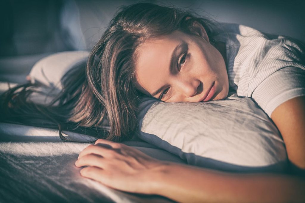 a woman going through drug withdrawal in bed should get to a medical detox center right away for help